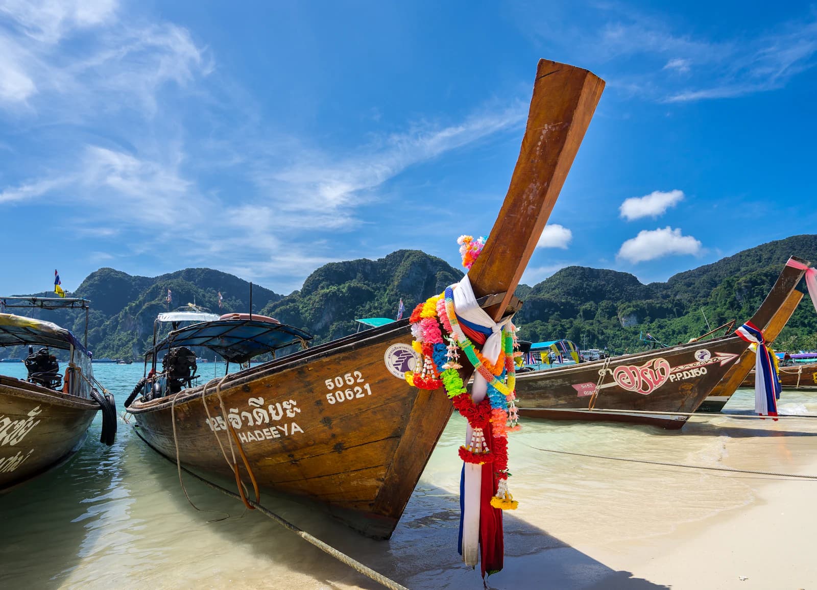 Longtail boats moored off a beach on Koh Phi Phi, Thailand