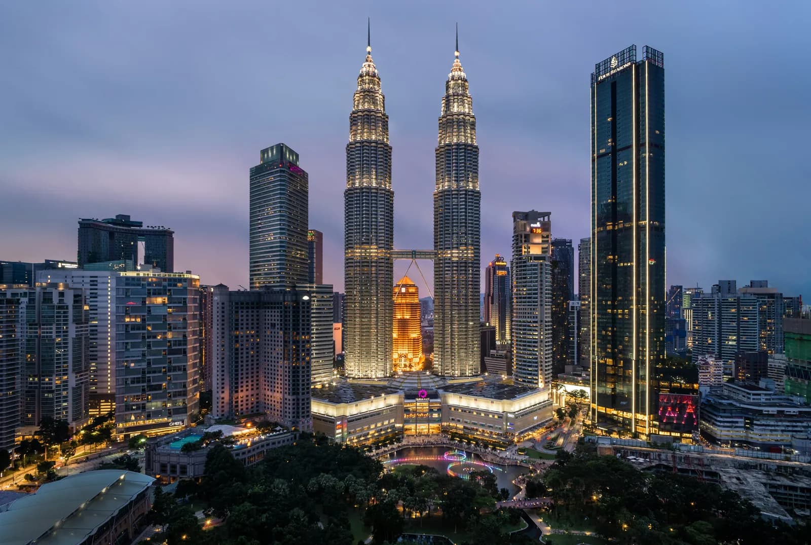 Petronas Twin Towers and the KLCC skyline at dusk in Kuala Lumpur