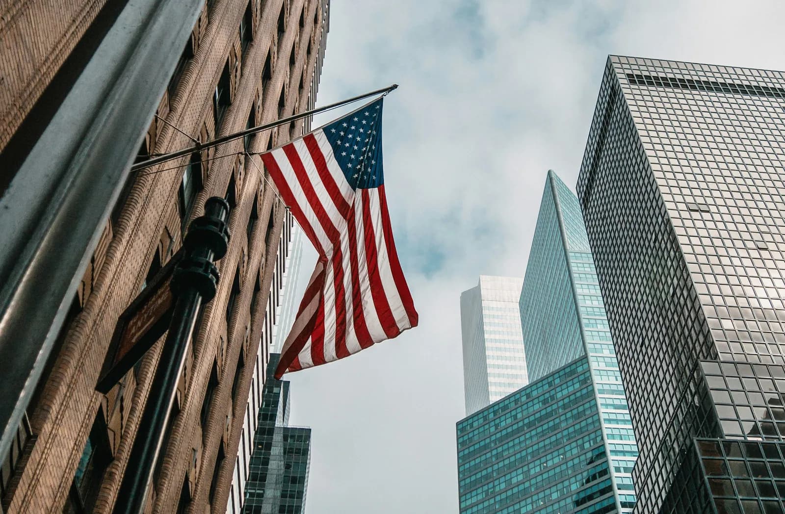 The American flag flying among Manhattan skyscrapers in New York City